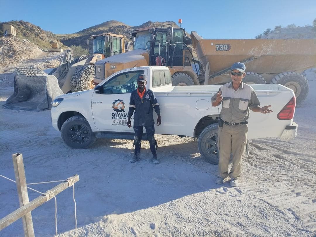 Qiyam team on site with support vehicle, loader, and dump truck