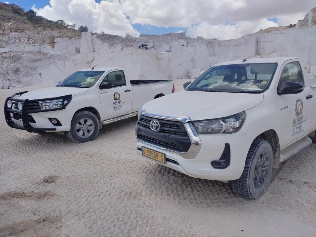 Qiyam support vehicles positioned on site at a quarry operation