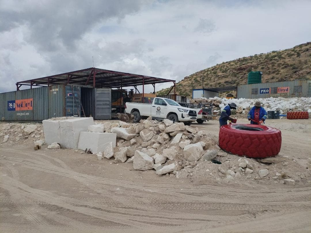 Qiyam support yard with service vehicles and workshop activity