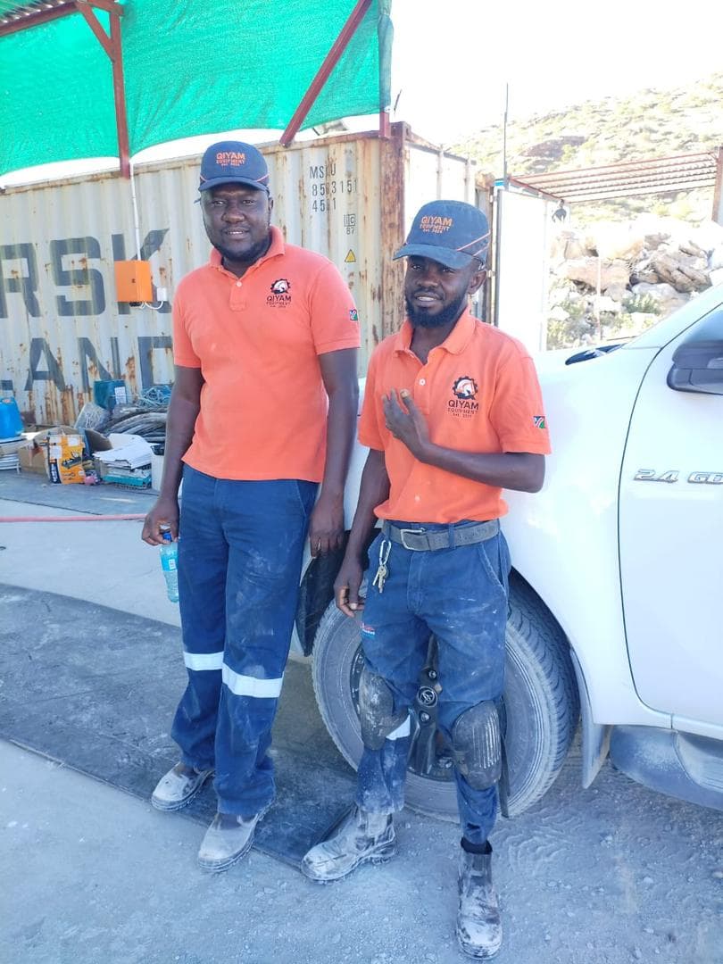 Qiyam technicians in branded workwear on site