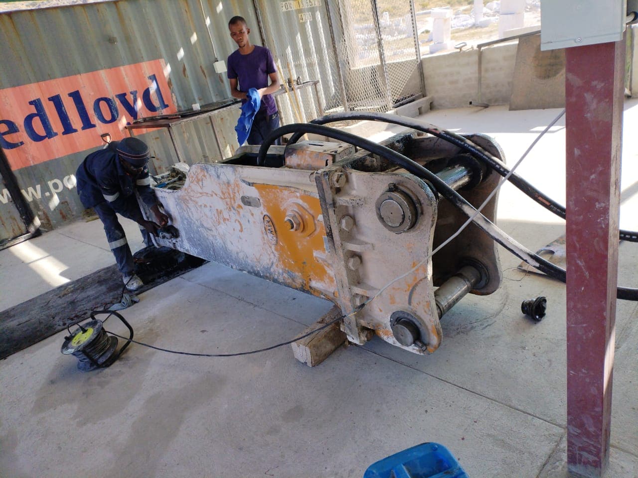 Qiyam technicians carrying out workshop repair work on heavy equipment attachment